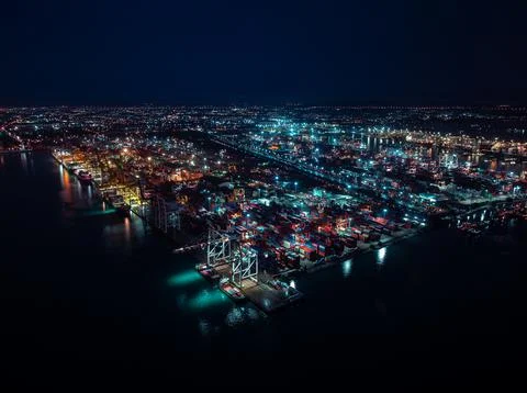 Illuminated Cargo Terminal Cranes Operating At International Shipping Port .. 写真素材