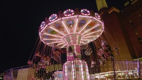 Illuminated Carousel Swing Ride At Battersea Power Station London At Night Stock Footage 344594233