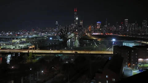 Illuminated Chicago Cityscape at Night Featuring Railway Tracks and Road Stock Footage 331774571