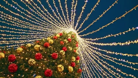 Illuminated christmas tree with radiating string lights at night Stock Footage 323208899