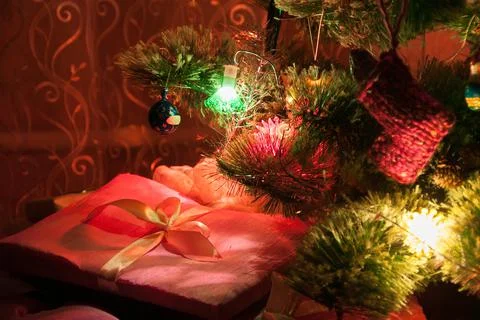 Illuminated Christmas tree with Santa Claus and wrapped gifts Stock Photos