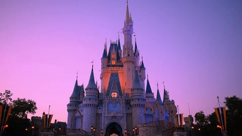 Illuminated Cinderellas Castle on sunset background Stock Footage 109170260
