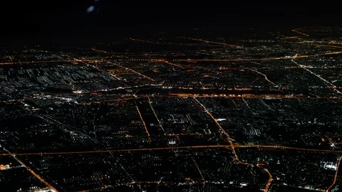 Illuminated city in dark night ,   aerial window seat view  airplane. Lights Stock Footage