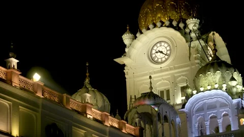 Illuminated Clock Tower at Golden Temple Complex at Night Stock Footage 331341089