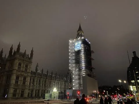 Illuminated Clock Tower Under Scaffolding at Night, City Landmark Stock Photos