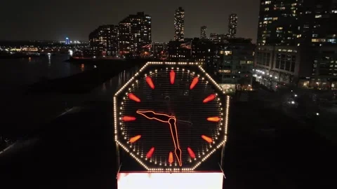 Illuminated clock at waterfront of New Jersey City at night. Skyline with Stock-Footage 297727613