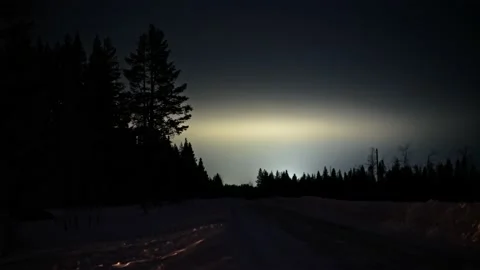 Illuminated clouds moving over forest silhouette Stock Footage 150881708
