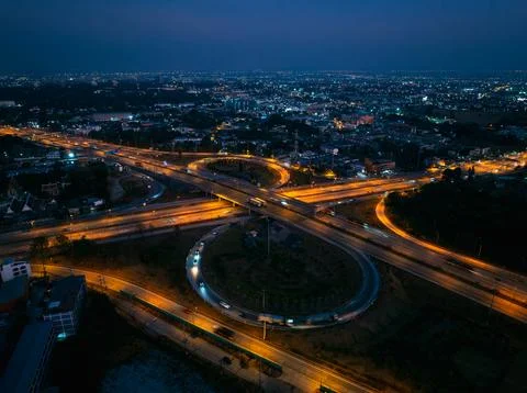 Illuminated Cloverleaf Highway Interchange With Light Trails At Night High .. Stock Photos