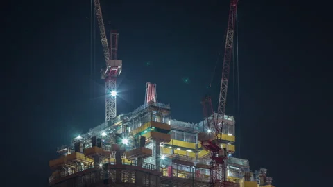 Illuminated construction cranes timelapse Dubai night aerial shot Stock Footage 337945848