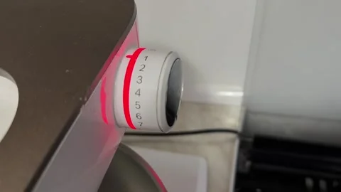 Illuminated control knob glowing red while kitchen food processor operates, Stock-Footage 337117490