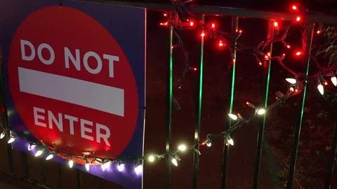 Illuminated Do Not Enter Sign Decorated with Festive Lights at Night Stock Footage 263929213