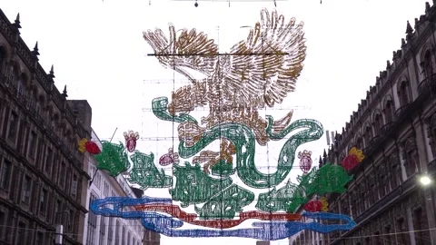 Illuminated Eagle and Serpent Decoration Above Historic Street in Mexico City Stock Footage 345718311