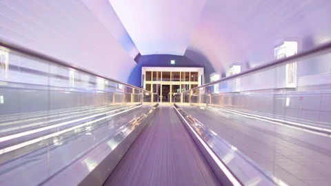 Illuminated, empty, multi colored moving walkway Stock Footage 75820136