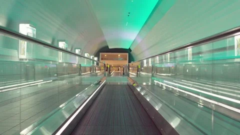 Illuminated, empty, multi colored moving walkway Stock Footage 75820138