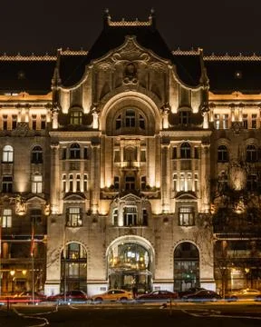 Illuminated facade of Gresham Palace at night in Budapest Stock Photos