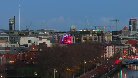 Illuminated Ferris Wheel Amidst Dublin's Evening Skyline Stock Footage 332444537
