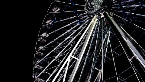 Illuminated ferris wheel at night  Stock Footage 284078129