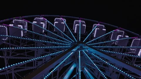 Illuminated Ferris Wheel Rotating Against Dark Night Sky Stock Footage 340194909