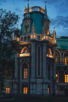 Illuminated Gothic tower with arched windows at dusk Stock Photos