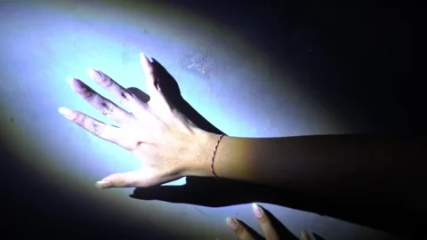 Illuminated Hand Reaching Towards Wall Stock Footage 313468115