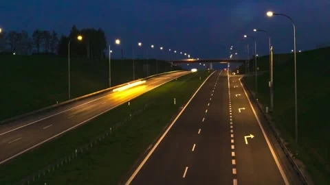 Illuminated Highway at Night with Motion Light Trails of Passing Vehicles Stockbeeldmateriaal 306665006