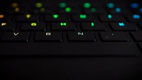 Illuminated keyboard buttons letters in multiple RGB colors Stock Footage 121287837