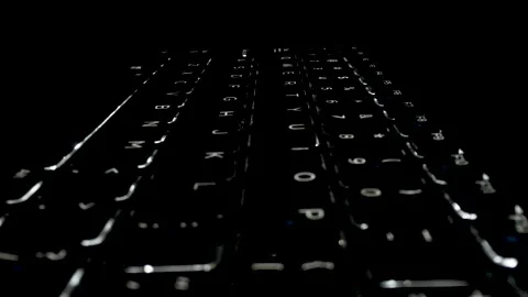 Illuminated keyboard with someone inspecting Video stock 134336815