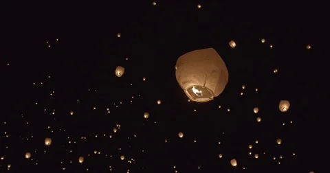 Illuminated lanterns flying in sky at night Stock Footage 73549010