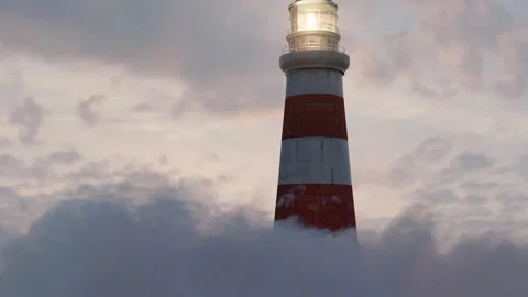 Illuminated lighthouse over fluffy clouds in the beautiful sunset Stock Footage 157262049
