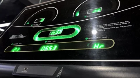 Illuminated metrics on a digital treadmill console display unit Stock Footage 307796351