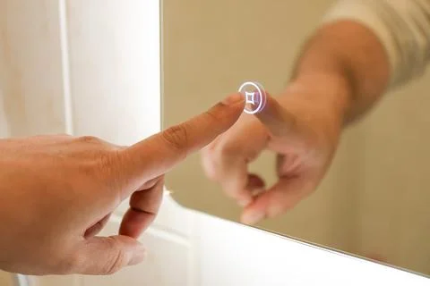 Illuminated mirror with touch control button Fotos de archivo