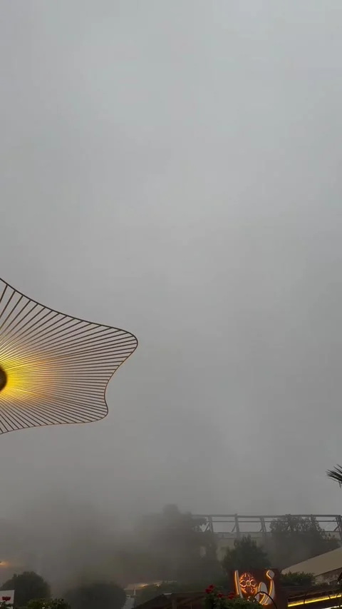 Illuminated Modern Sun Umbrella Under Foggy Evening Sky 库存影片 342264032