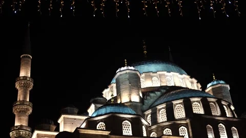 Illuminated mosque with blue domes and minarets at night Stock Footage 321001026
