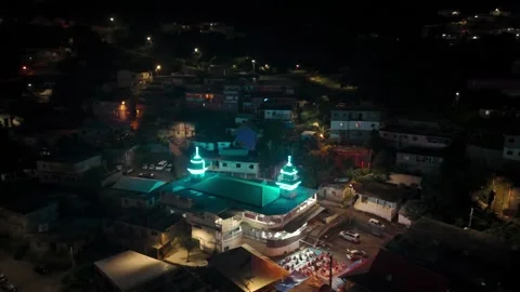 Illuminated Mosque with people breaking fast during Ramadan Stock Footage 279880572