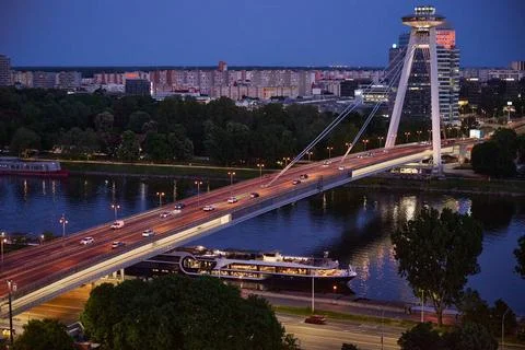 Illuminated Most SNP bridge deck spanning the Danube river at night with a la Stock Photos