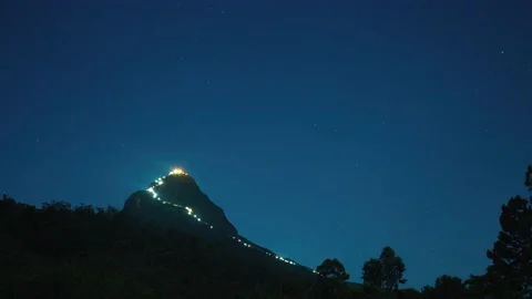 Illuminated mountain peak and starry sky Stock Footage 175333186