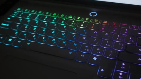 Illuminated multi-colored keyboard of a laptop Stock Footage 318790956