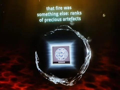 Illuminated museum artifact display with circular medallion and projection .. Stock Photos