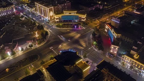 Illuminated Nyingchi intersection in rotating night aerial Stock Footage 345876047
