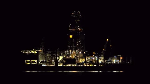 Illuminated offshore oil platform operates - Offshore Energy and Oil Operation Stock Footage 339946183