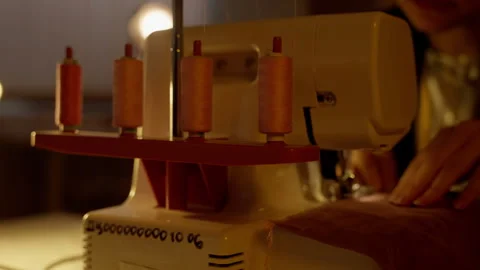 Illuminated Overlock Sewing Machine with Thread Spools. Overlock sewing machine Stock Footage 264376926