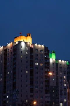 Illuminated panel, multi-storey buildings in the distance. An evening in Mins Stock Photos