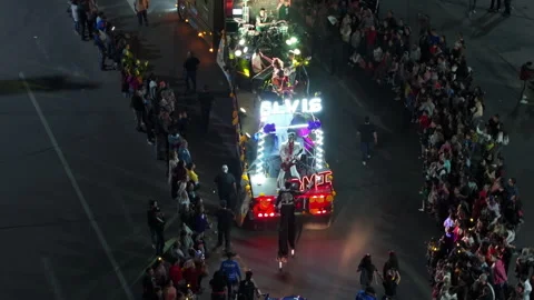 Illuminated parade float with live band performing for crowds at night. Stock Footage 337905097