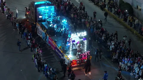 Illuminated parade float with live band and performers moves through crowded. Video stock 337905108