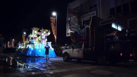 Illuminated parade float with support pickup truck behind at Loy Krathong Stock Footage 337941293