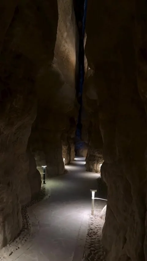 Illuminated Pathway Through Narrow Rocky Cave Canyon Stock Footage 342268091