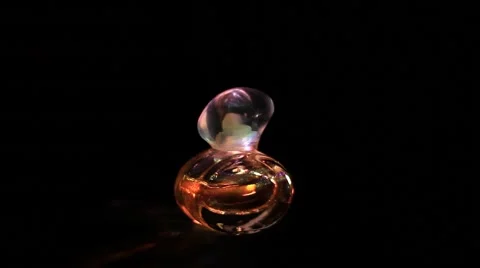 Illuminated perfume bottle Stock Footage