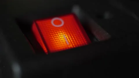 Illuminated power switch on a socket with a European Schuko plug as a symbol  動画素材 220105349