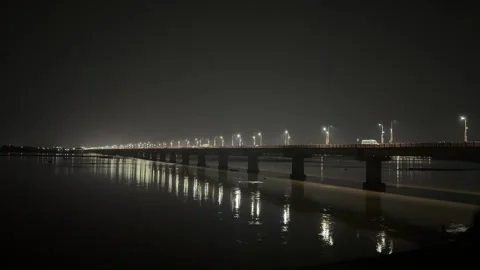 Illuminated River Bridge at Night with Reflections on Calm Water Video stock 340500012
