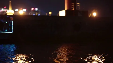 Illuminated river bus floating on waves at night. Video stock 77233578